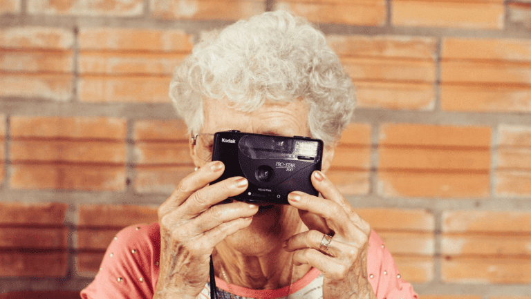 Oma mit Kamera, die ein Foto macht