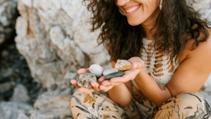 Frau hält Steine in der Hand: Fondsausschüttung reinvestieren